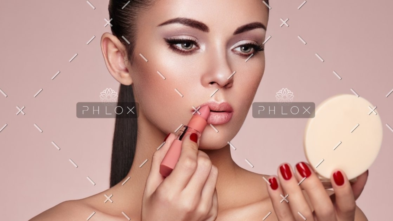 demo-attachment-551-beautiful-woman-paints-lips-with-lipstick-PMB6YWP-1